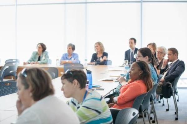 faculty in a classroom at tables